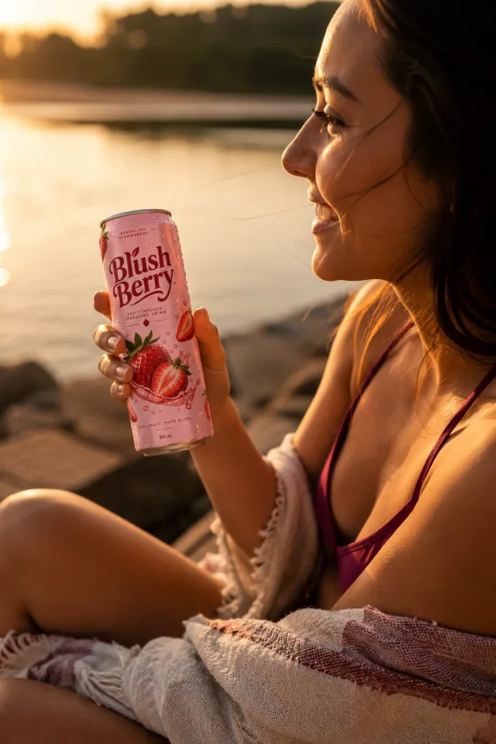 A person enjoying a Blush Berry can outdoors